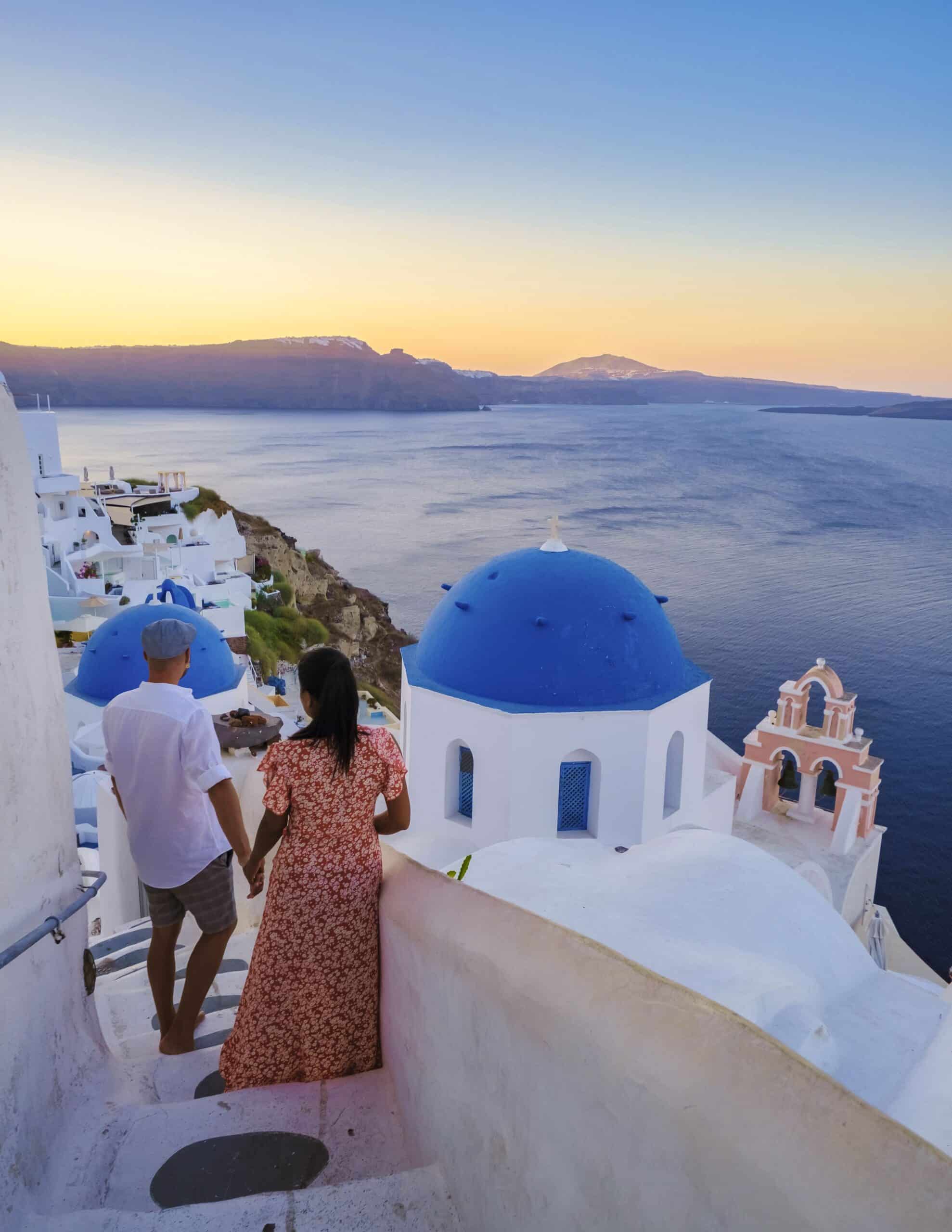 Couple on vacation in Santorini Greece, men, and women on the streets of the Greek village of Oia Santorini