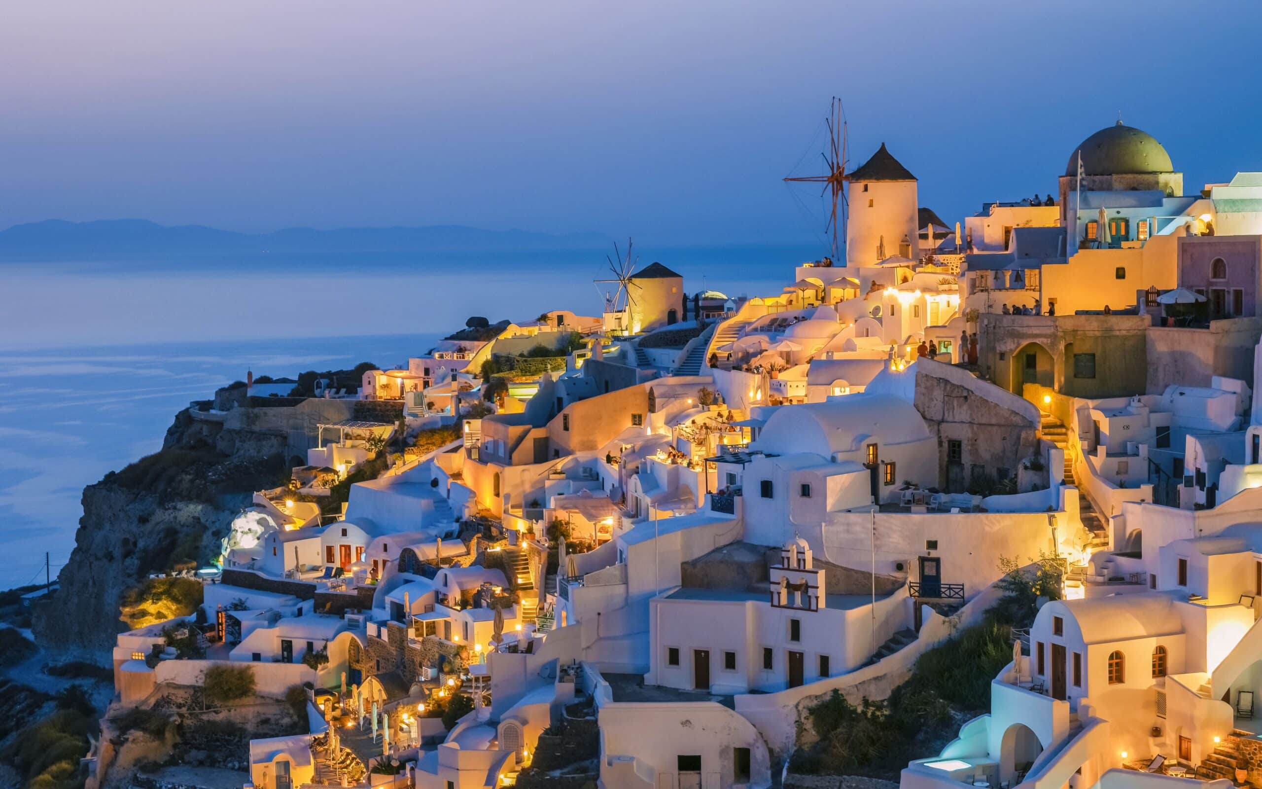 Sunset at the village of Oia Santorini Greece during summer with whitewashed homes and churches, Greek Island Aegean Cyclades